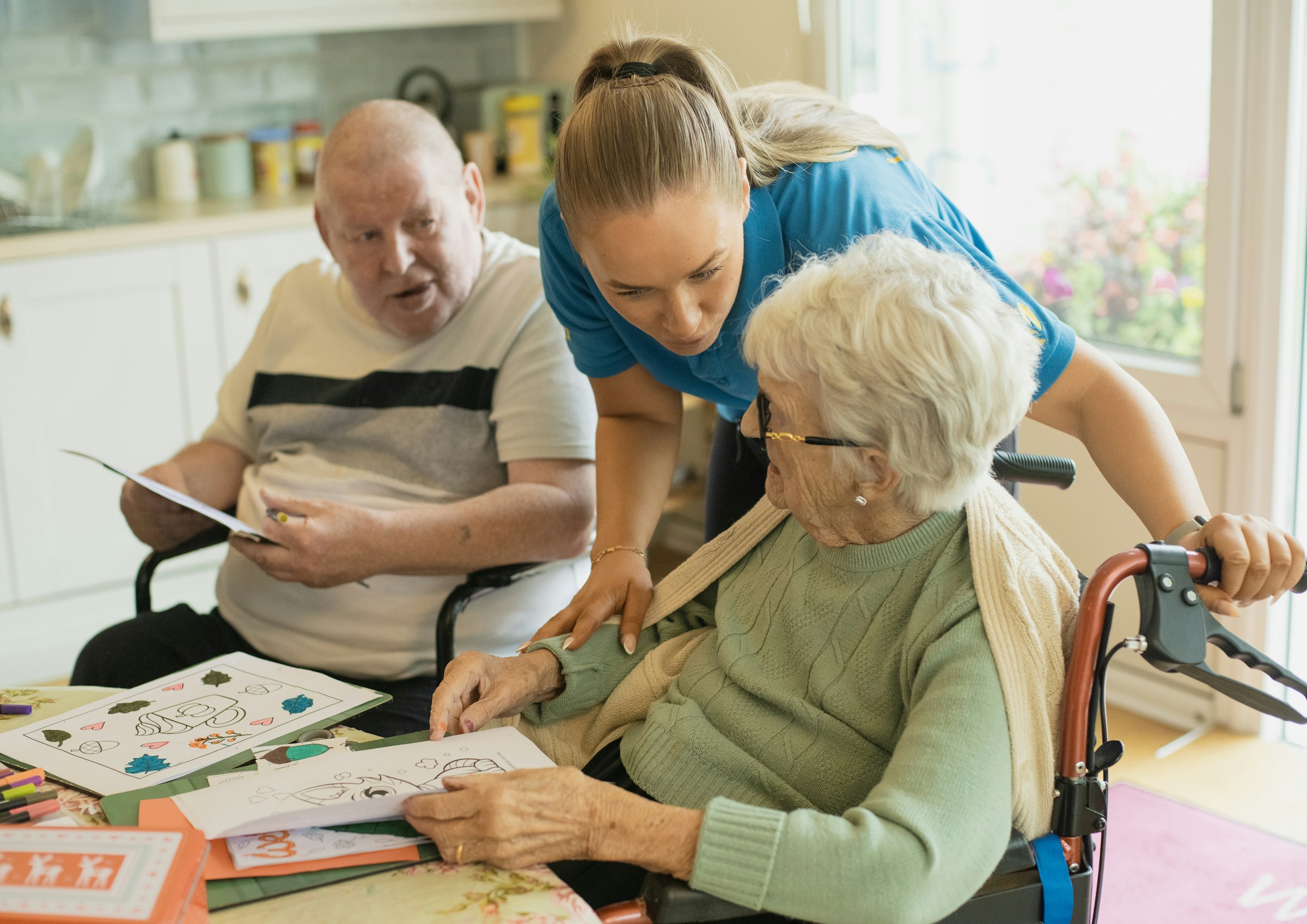 An older couple enjoying time at home with a family caregiver
